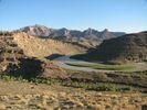 A broad landscape of rugged mountains and canyons in the morning light