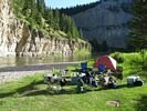 Rafting party campsite in the morning light with bright green grass everywhere