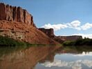 The red cliffs beside the Green River reflecting in the water
