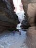 Two men walking in a dramatic slot canyon