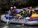 A whitewater raft with all occupants dressed in rain gear on the Middle Fork of the Salmon, Idaho