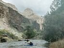 Two kayaks approaching with the Bruneau River canyon as the backdrop